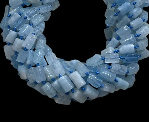Necklace made of light blue beads with blue accents on a black background